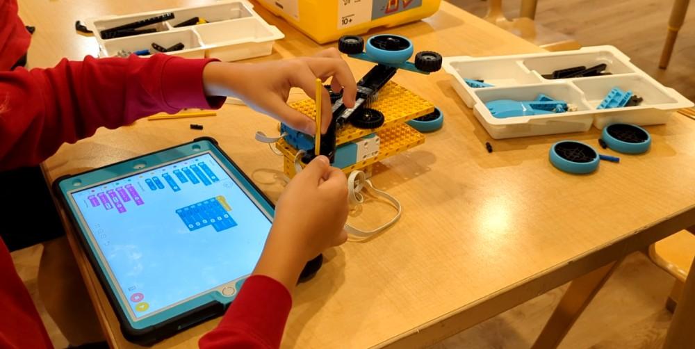 A student programming a machine they constructed out of lego